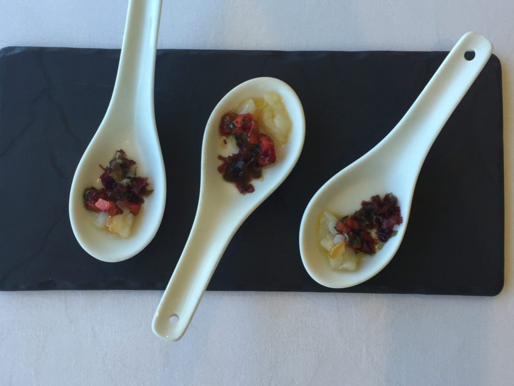 Jonah’s Restaurant amuse Boucher: Creamy Scallop ceviche contrasts with deep red roasted diced strawberries, served on small white ceramic spoons